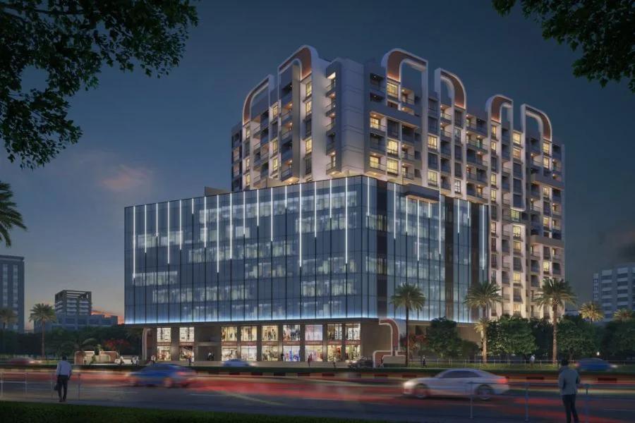 Glass-fronted podium and tower lit at night at EH Towers Commercial, Tathawade (copy 2)
