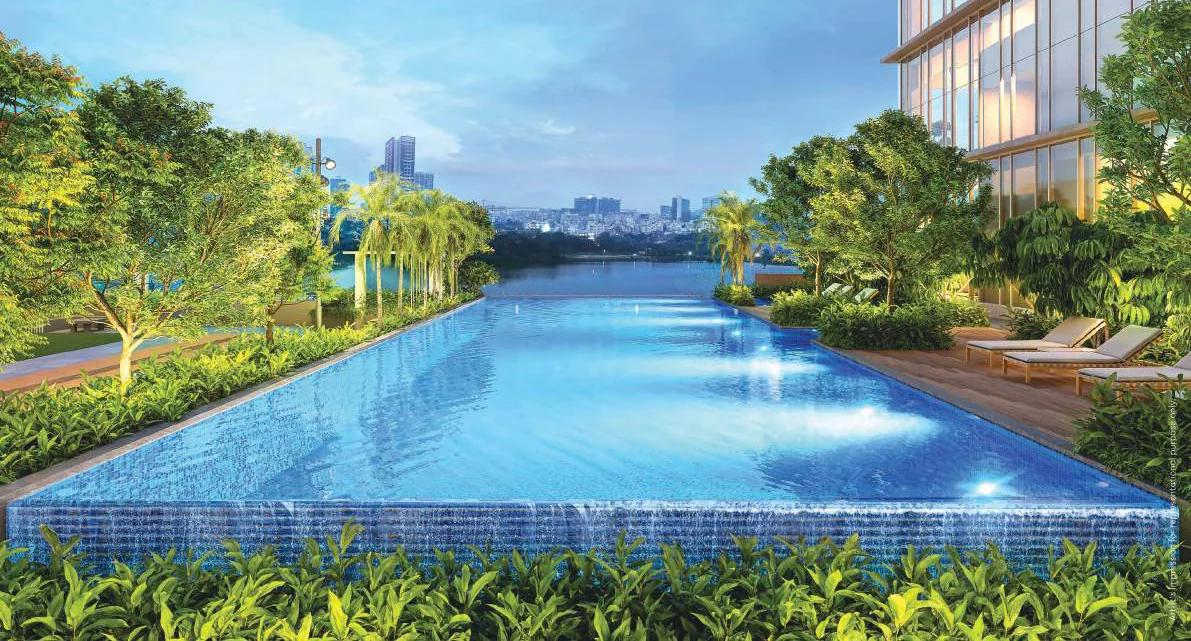 River-facing swimming pool with loungers at Godrej Aqua Vista, Keshav Nagar