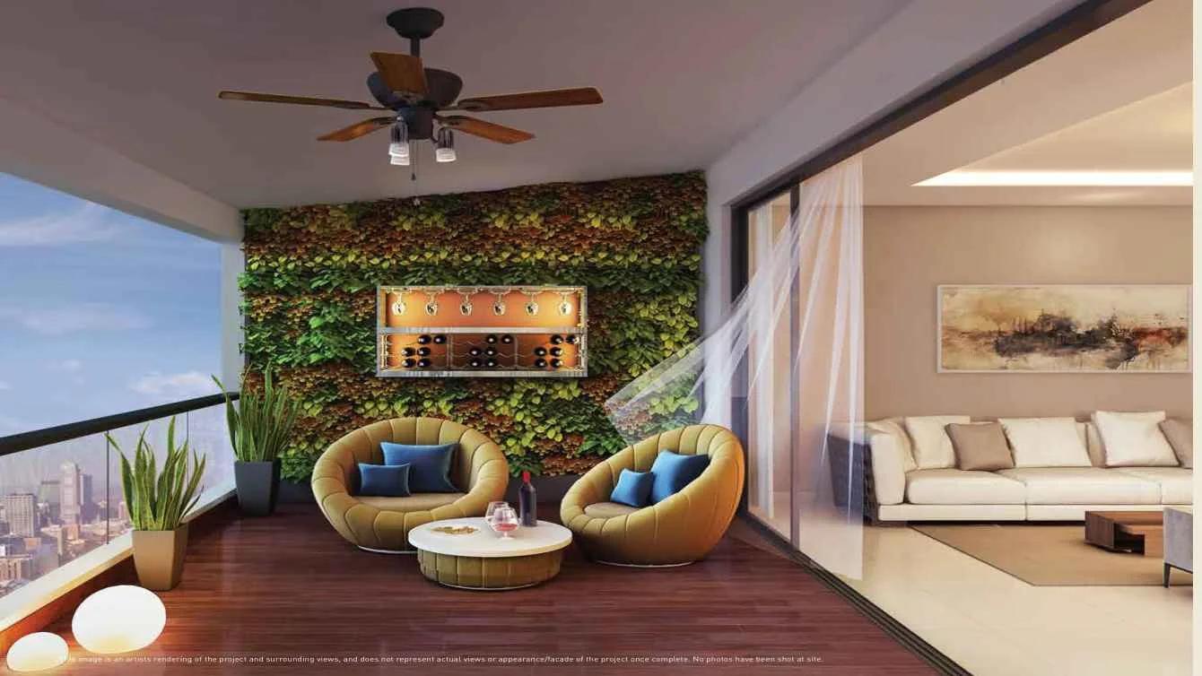 Balcony lounge with seating and a green wall at Aspire Puravankara, Bavdhan